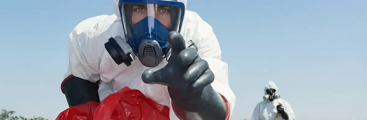 sewage clean up technician wearing protective gear handling biohazard materials in Minneapolis, MN