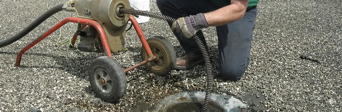 sewer rodding technician actively removing blockages from a sewer line in Minneapolis, MN