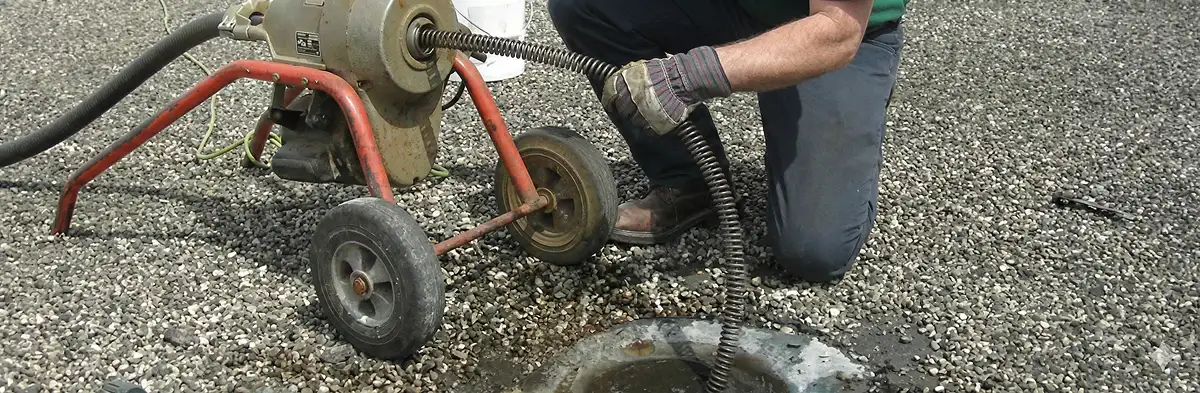 sewer rodding technician actively removing blockages from a sewer line in Minneapolis, MN