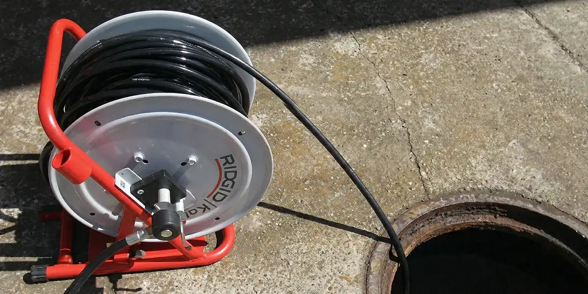 sewer rodding equipment prepared to clear clogged sewer lines in Minneapolis, MN